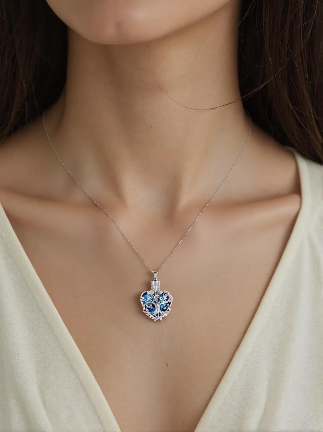 woman wearing tree of life urn necklace with blue crystal